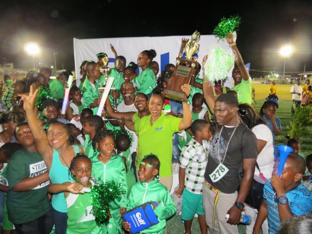 Students of the St. Thomas Primary School celebrate their win in Division A at the during the presentation ceremony at the end of the 24th Gulf Insurance Athletics Championships at Elquemedo T. Willet Park on March 30, 2016 with Marketing Manager of Gulf Insurance Ms. Lisa Hutson